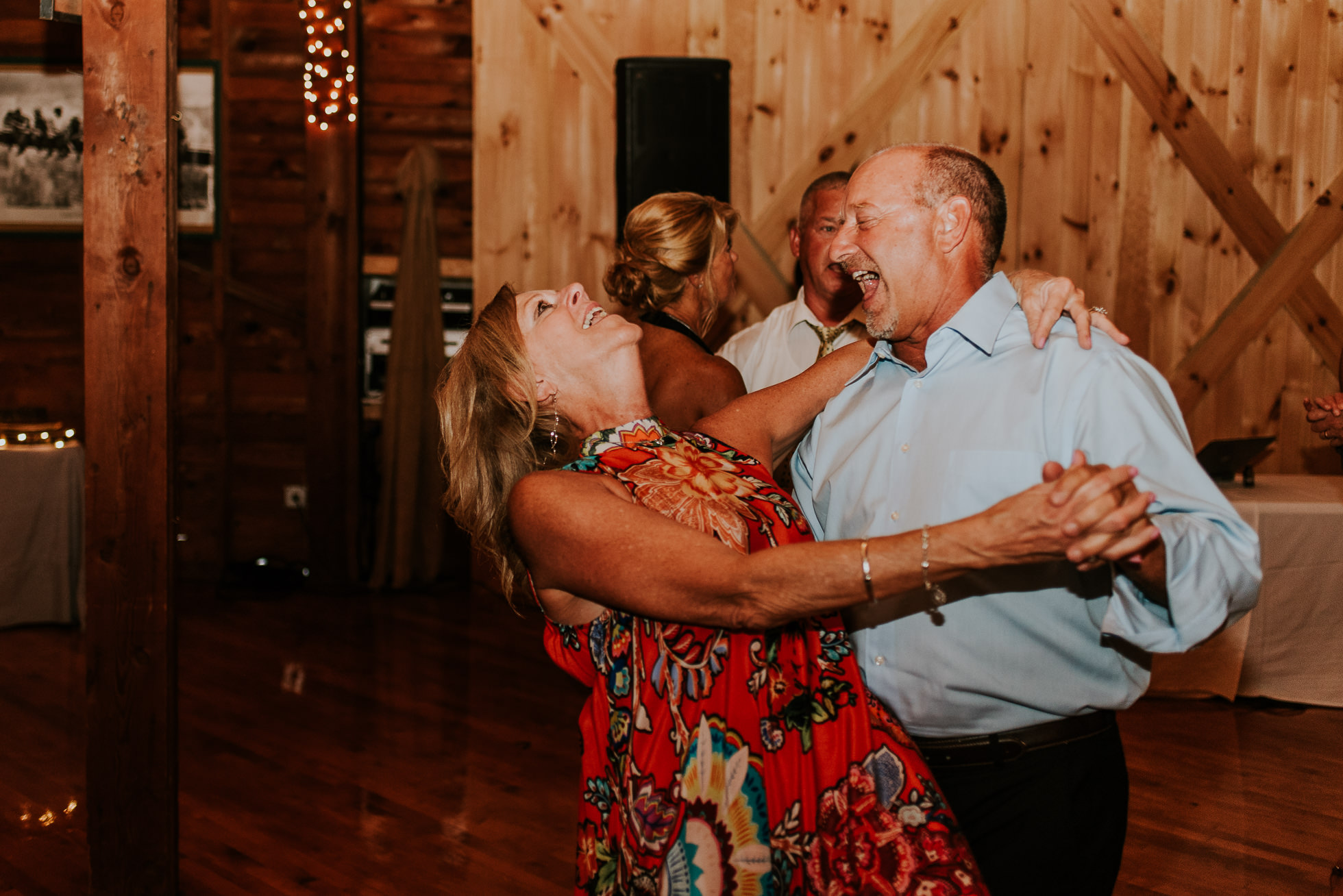 guests dancing at olde tater barn wedding in central bridge, ny photographed by traverse the tides