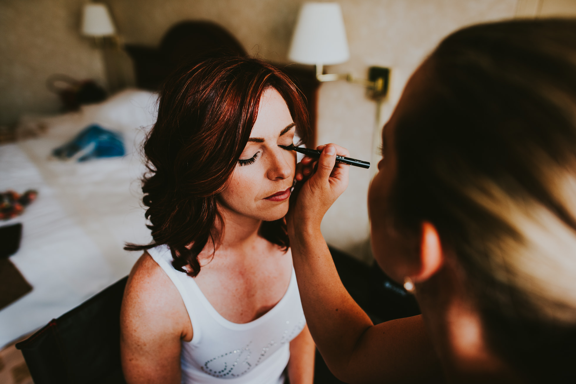 bride getting makeup done at olde tater barn in central bridge, ny photographed by traverse the tides