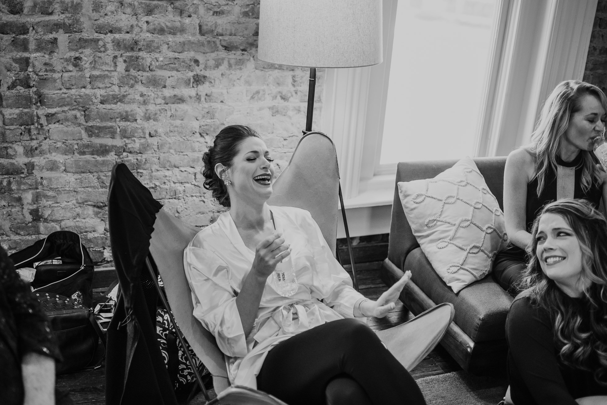 bride laughing at getting ready