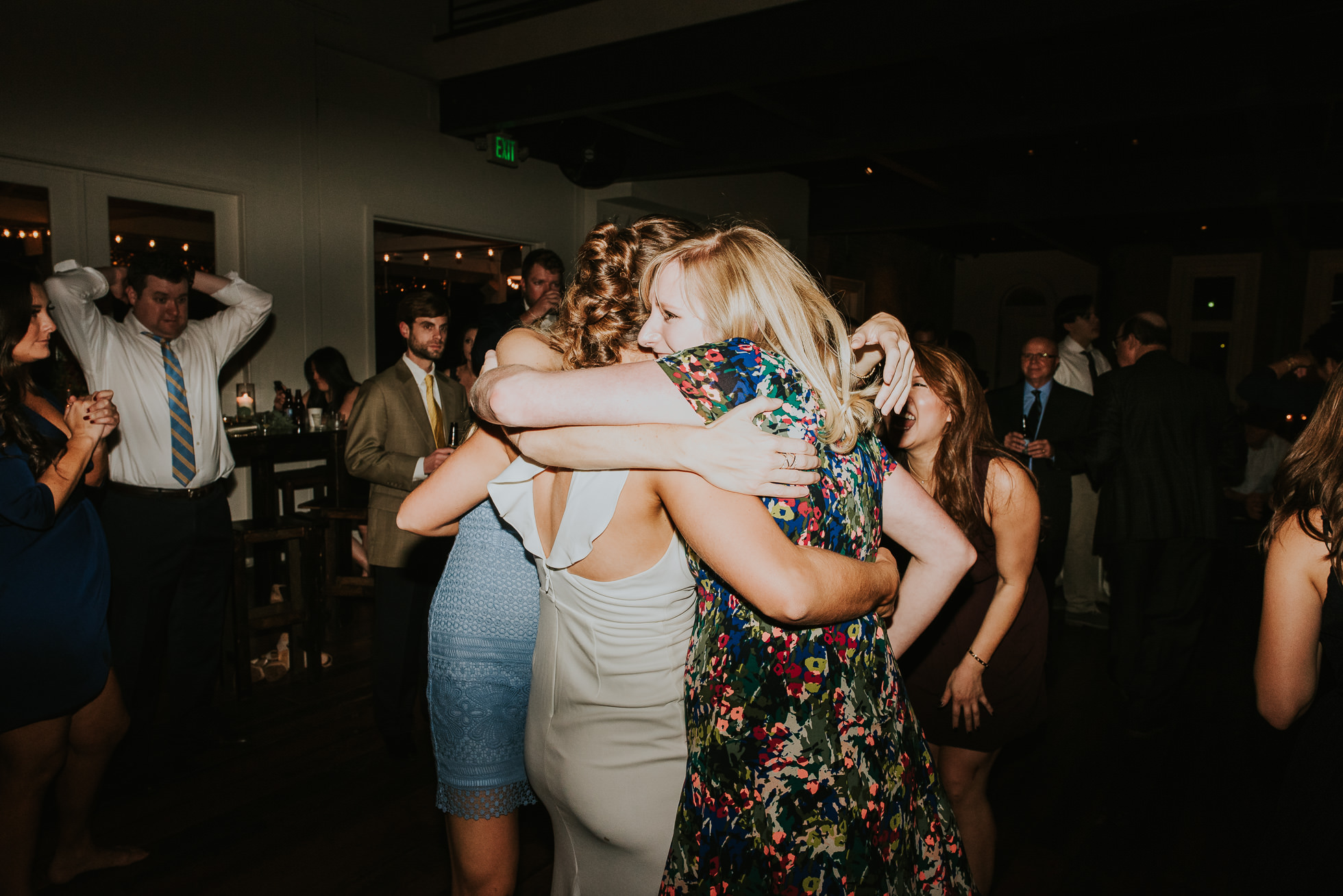 bride and friends hugging at wedding reception at the cordelle nashville wedding