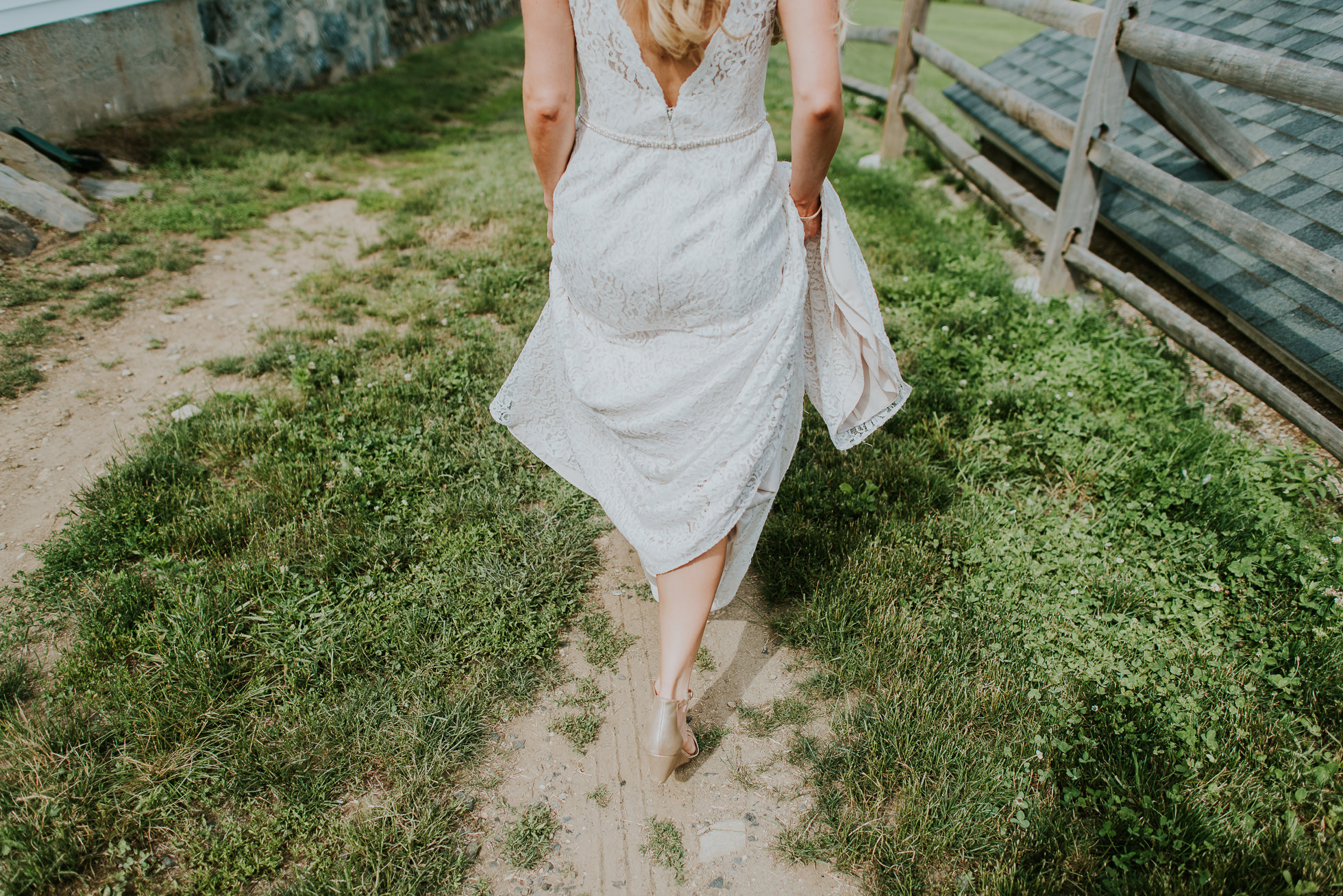 bride walking on a farm photographed by Traverse the Tides