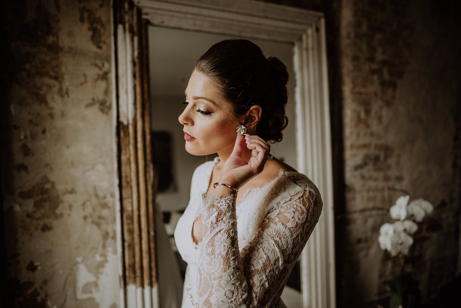 bride putting on earrings the cordelle nashville wedding