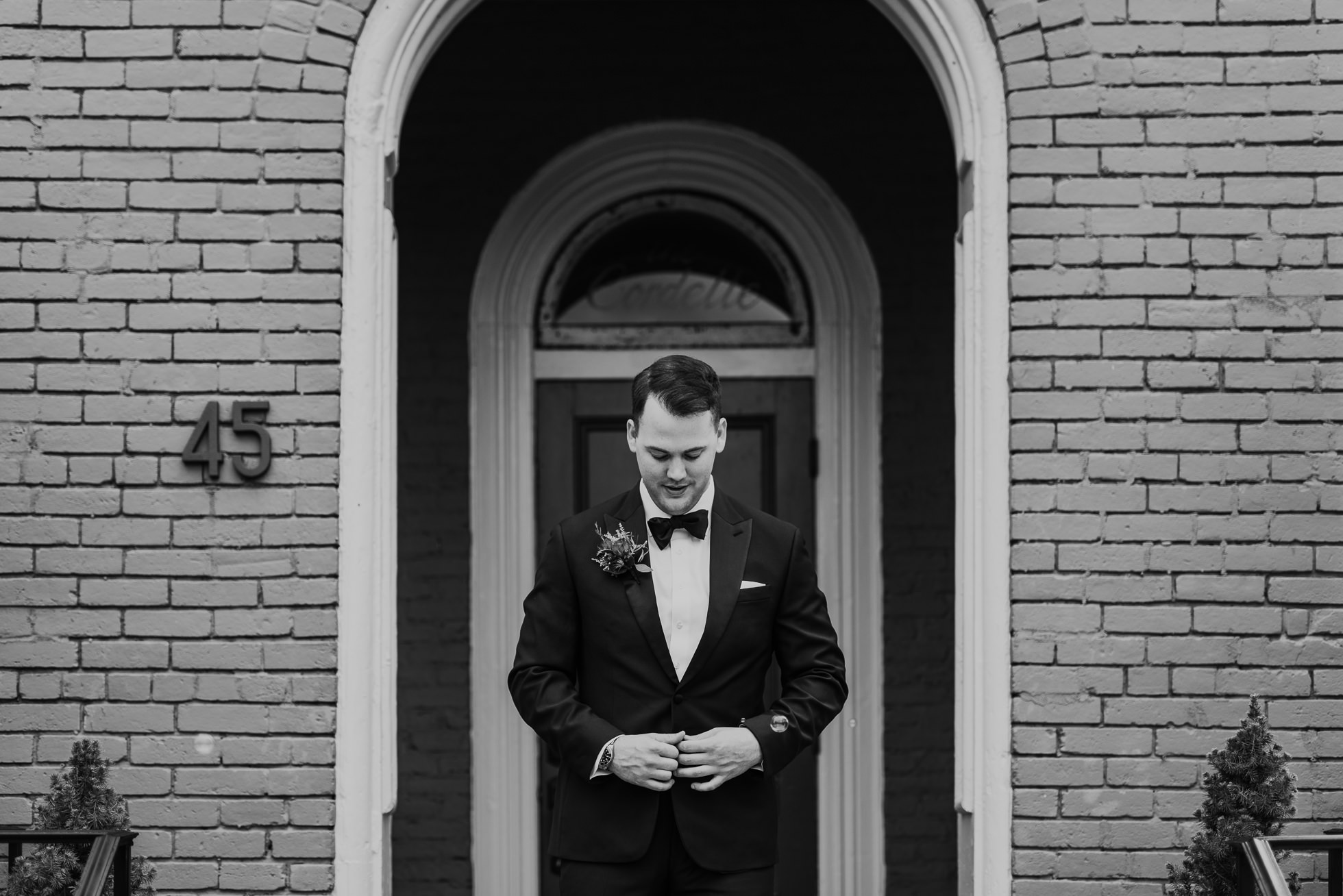 groom buttoning jacket the cordelle nashville wedding