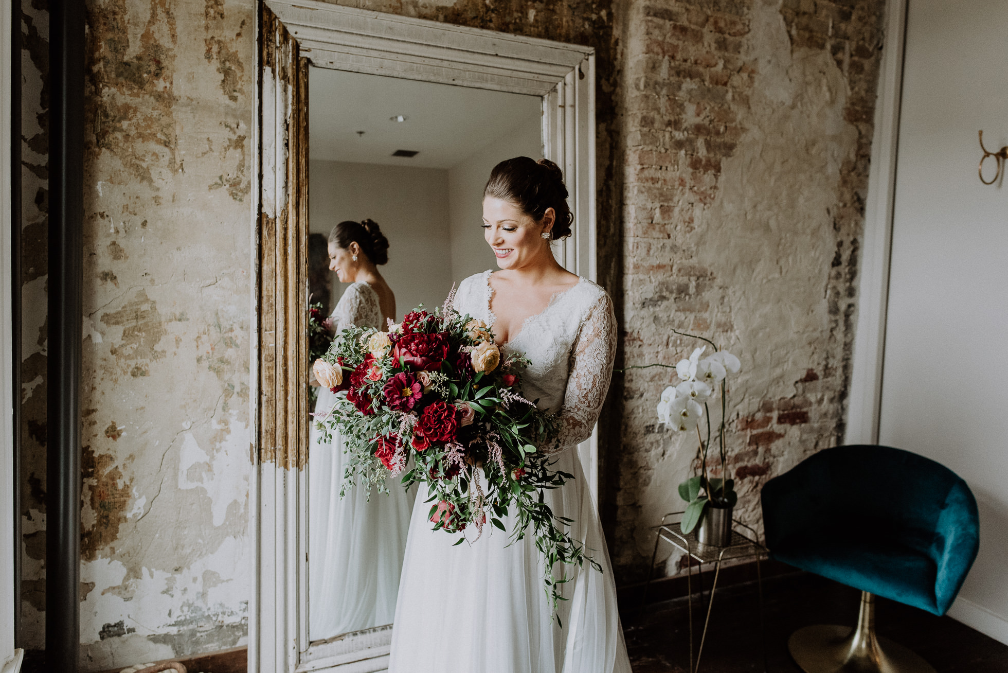 bride with red wedding bouquet the cordelle nashville wedding