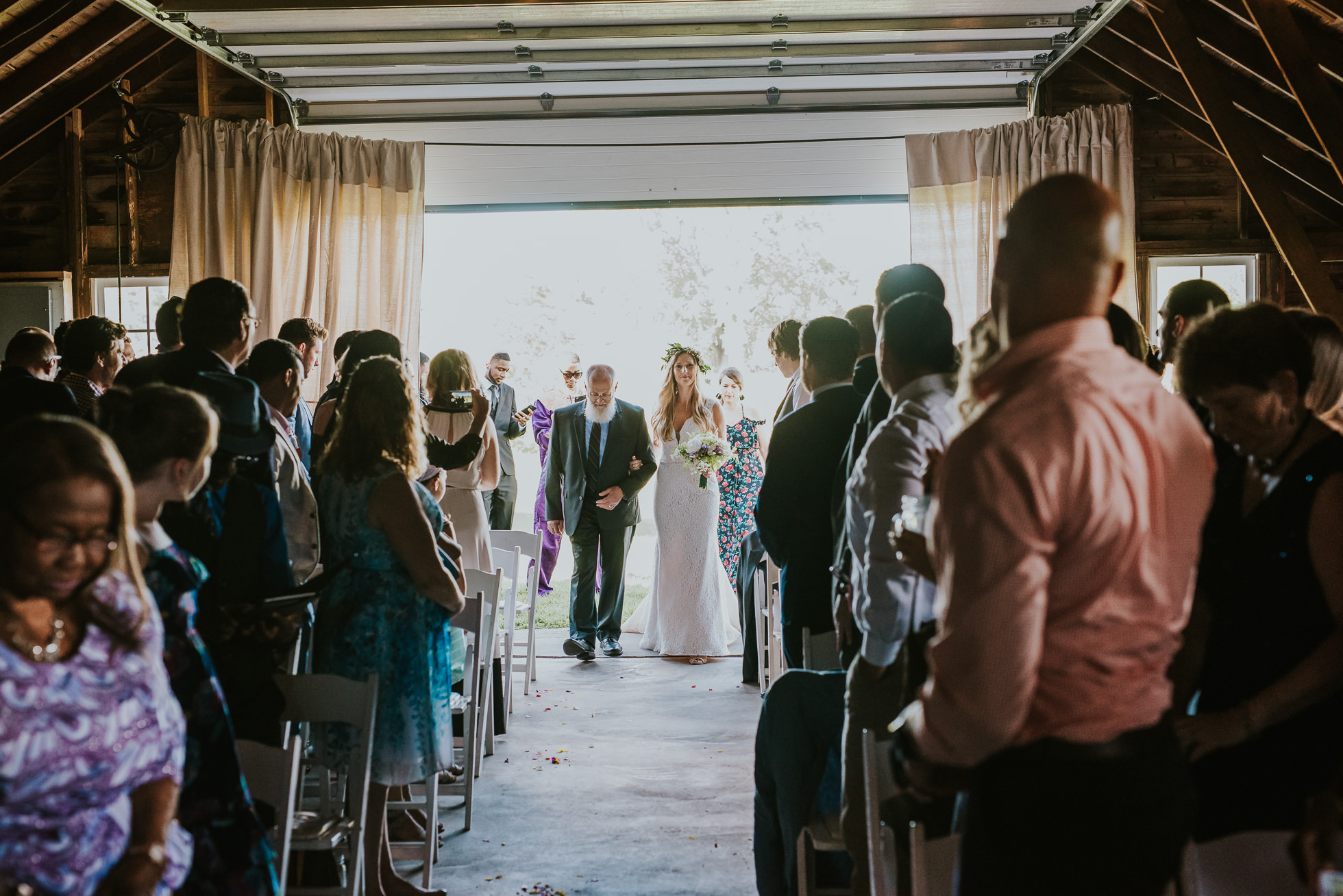 bride walking down the aisle photographed by Traverse the Tides