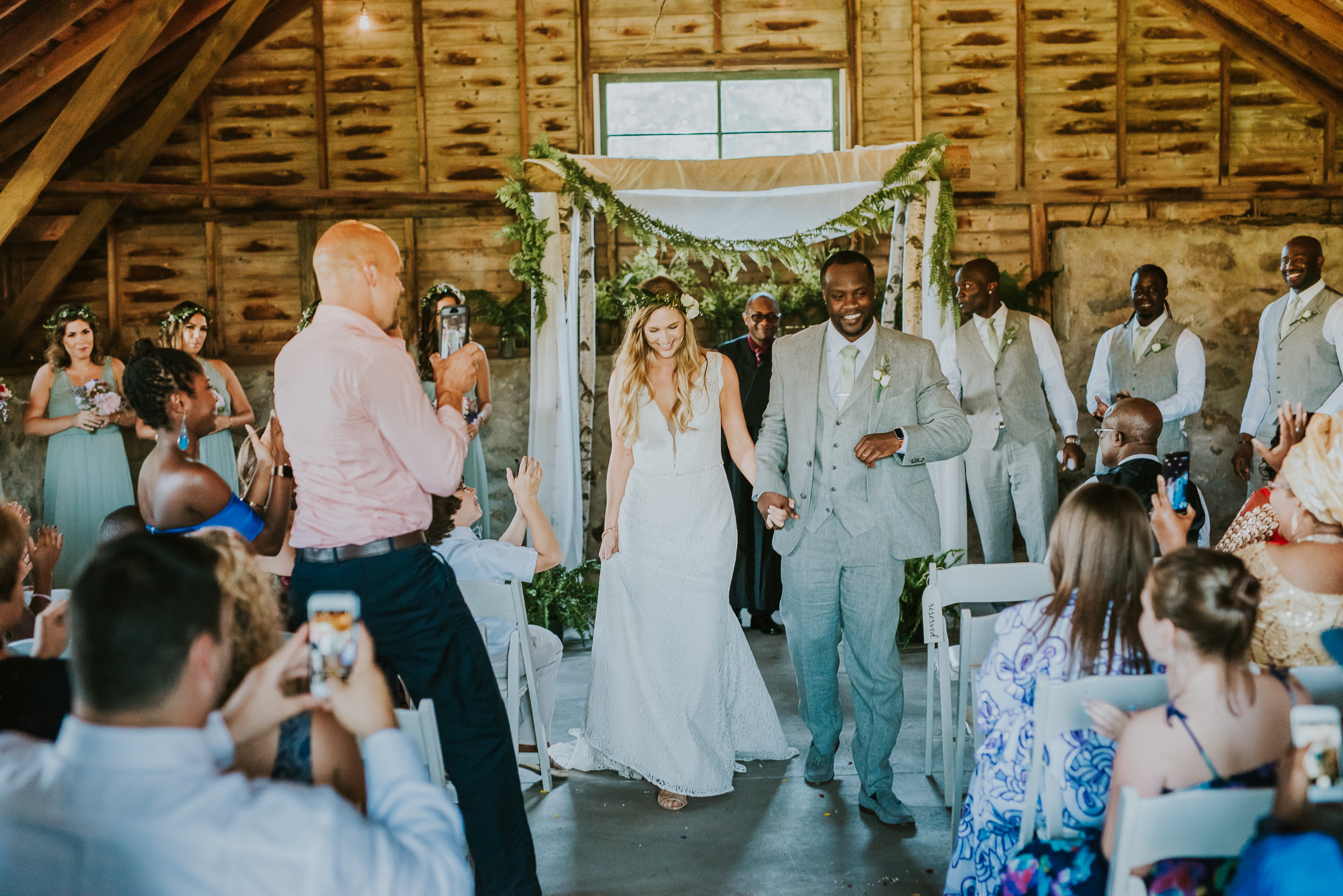 bride and groom exit rustic wedding photographed by Traverse the Tides