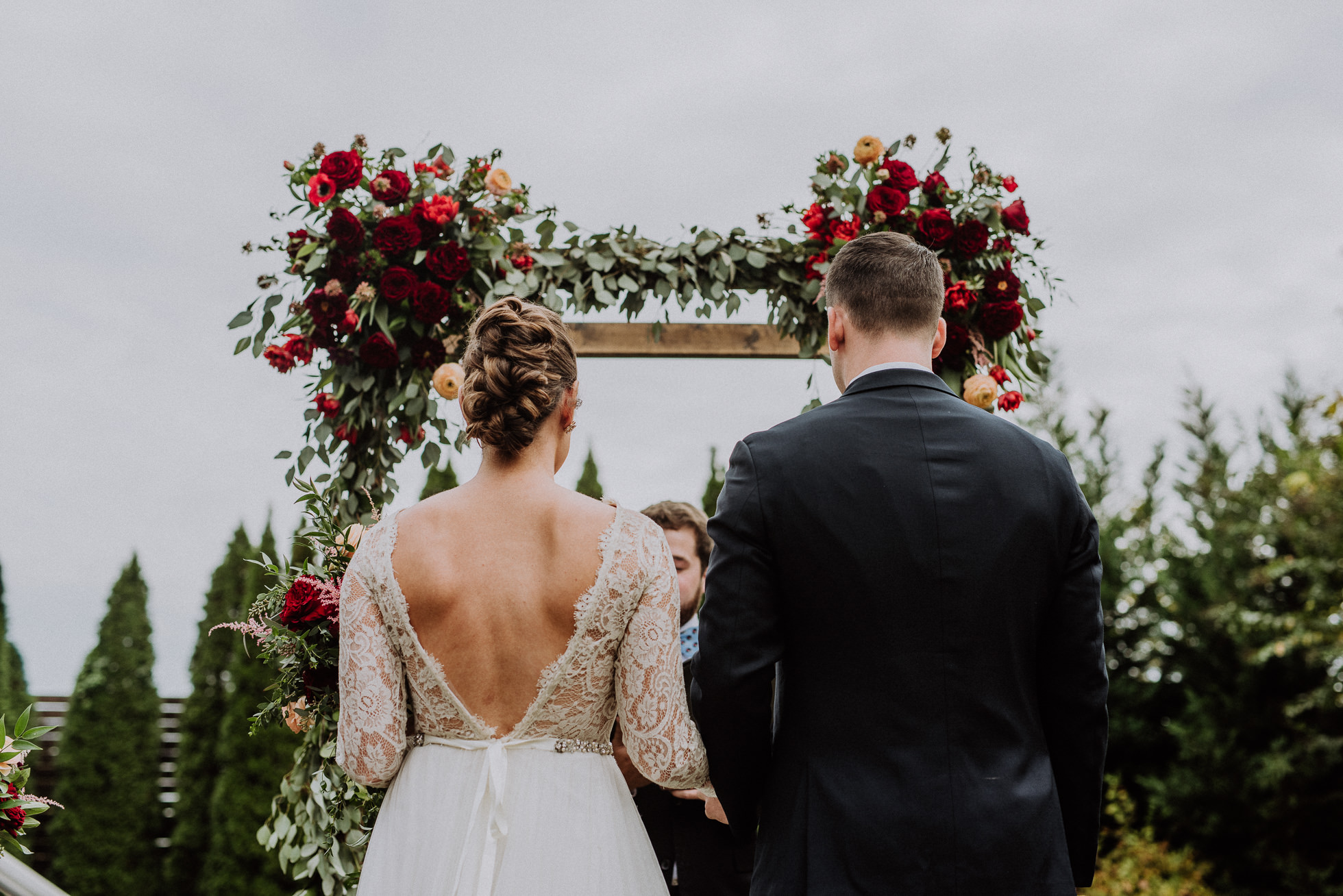 bride and groom in front of floral arch the cordelle nashville wedding