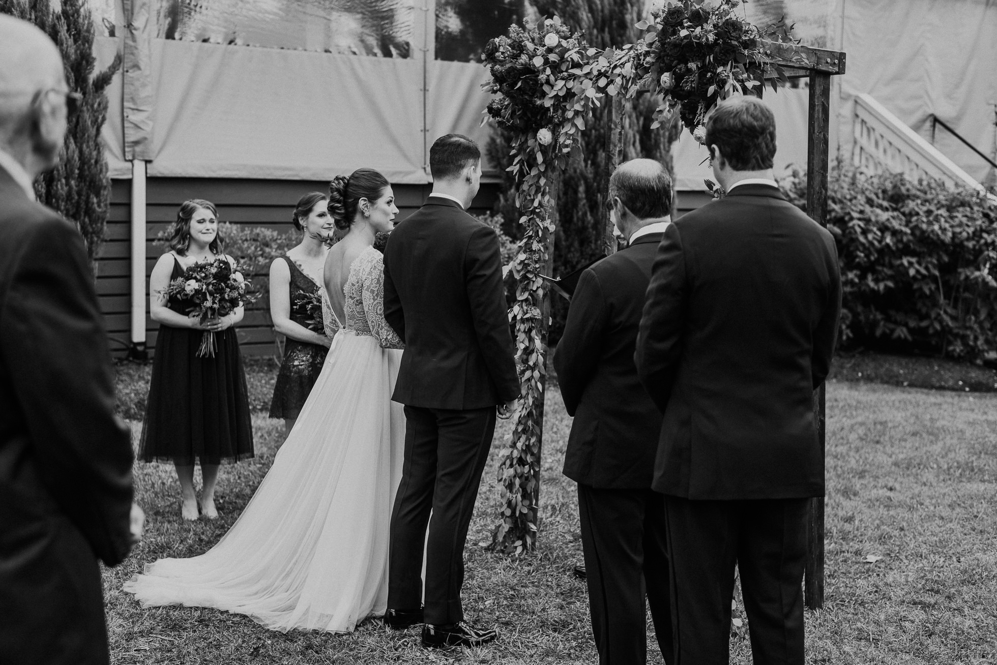 bride and groom in front of floral arch the cordelle nashville wedding