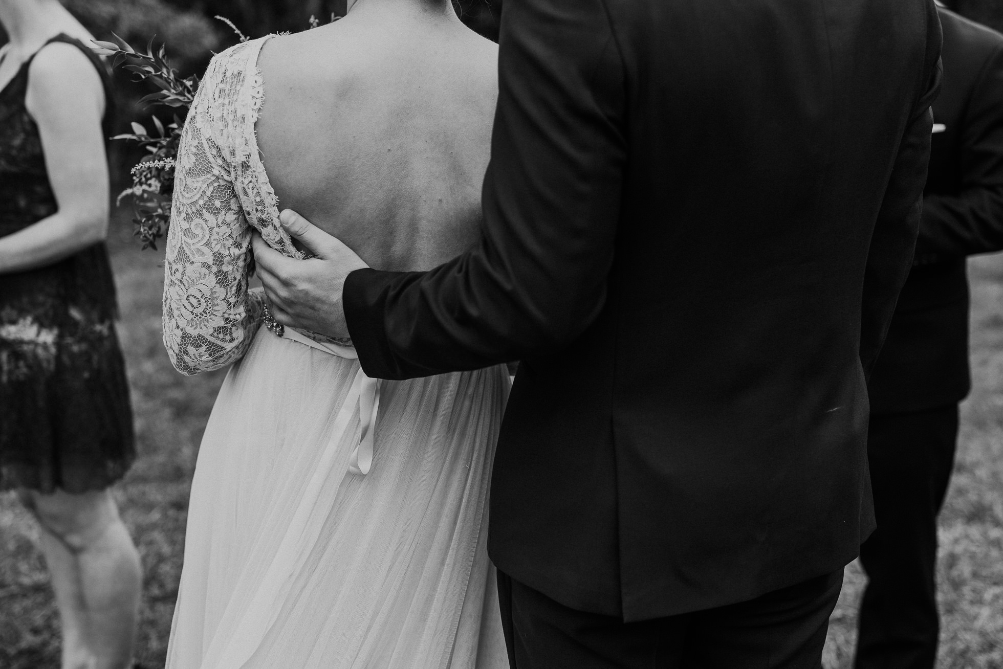 groom hugging bride at ceremony