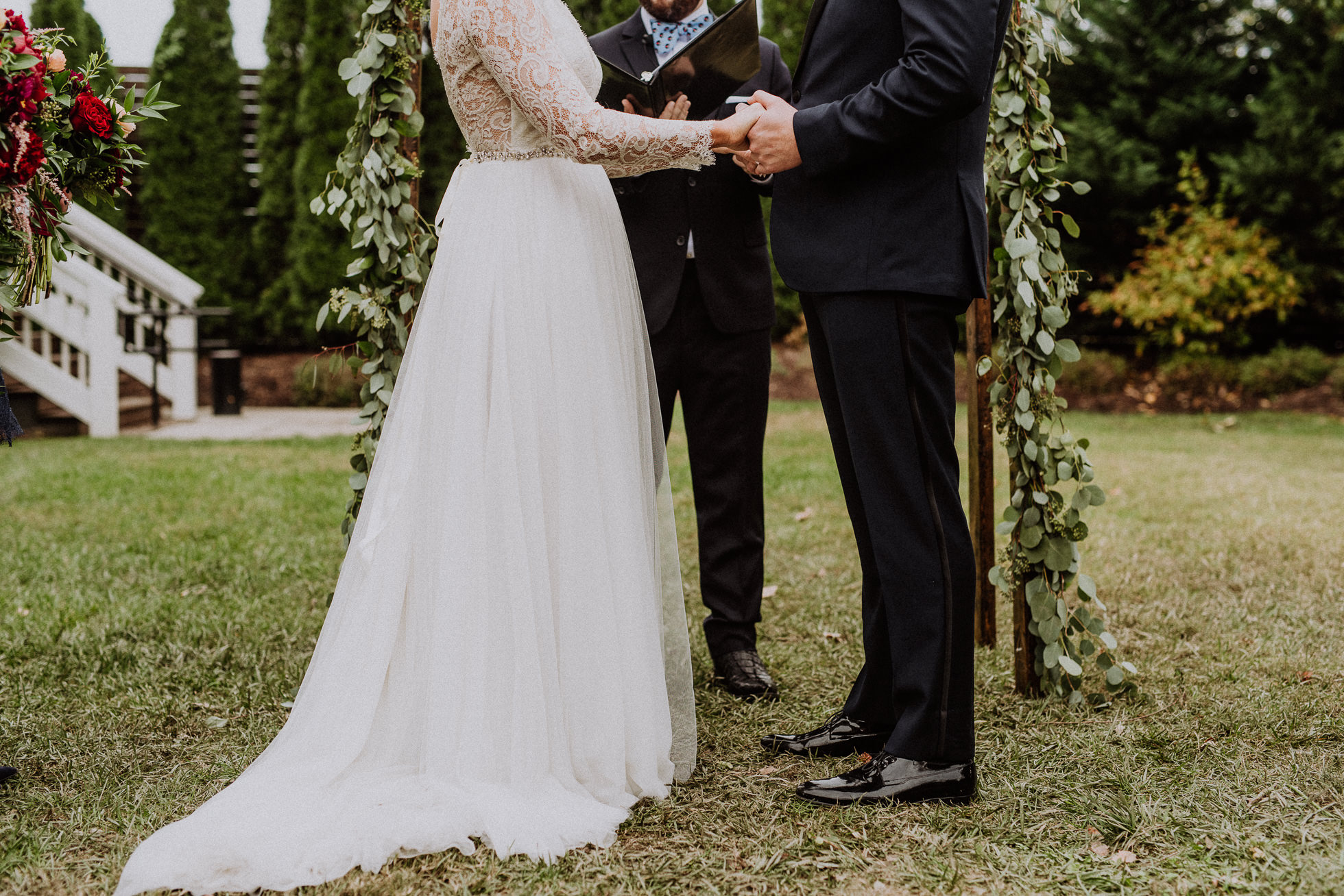 bride and groom holding hands at ceremony the cordelle nashville wedding