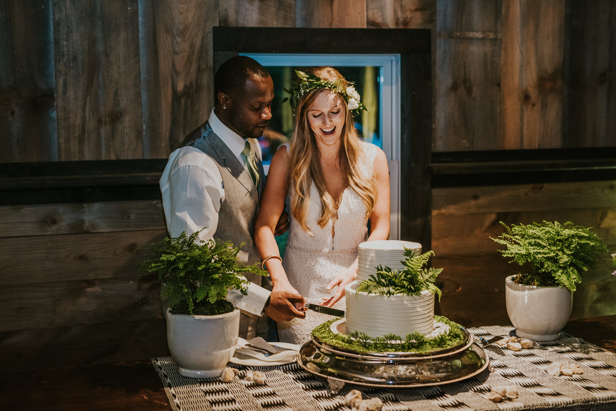 rustic wedding cake cutting photographed by Traverse the Tides