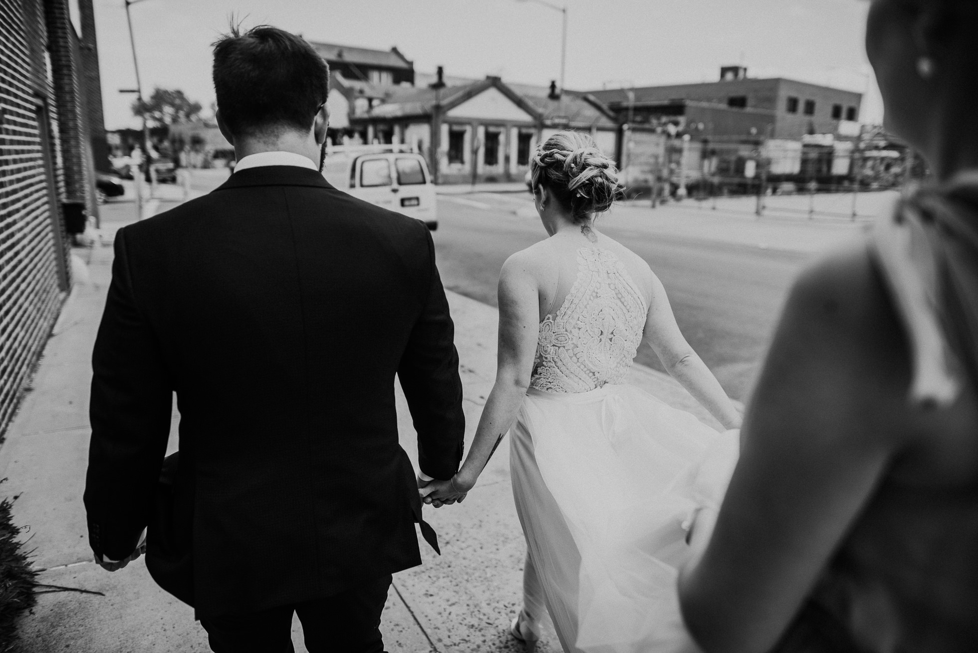 bride and groom holding hands photographed by Traverse The Tides