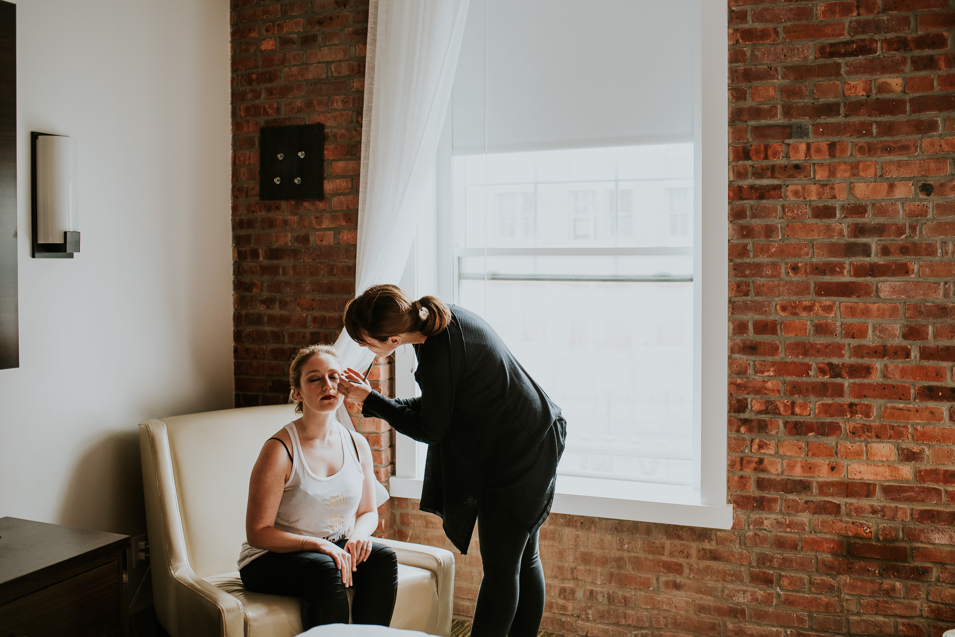 Bride getting makeup photographed by Traverse The Tides