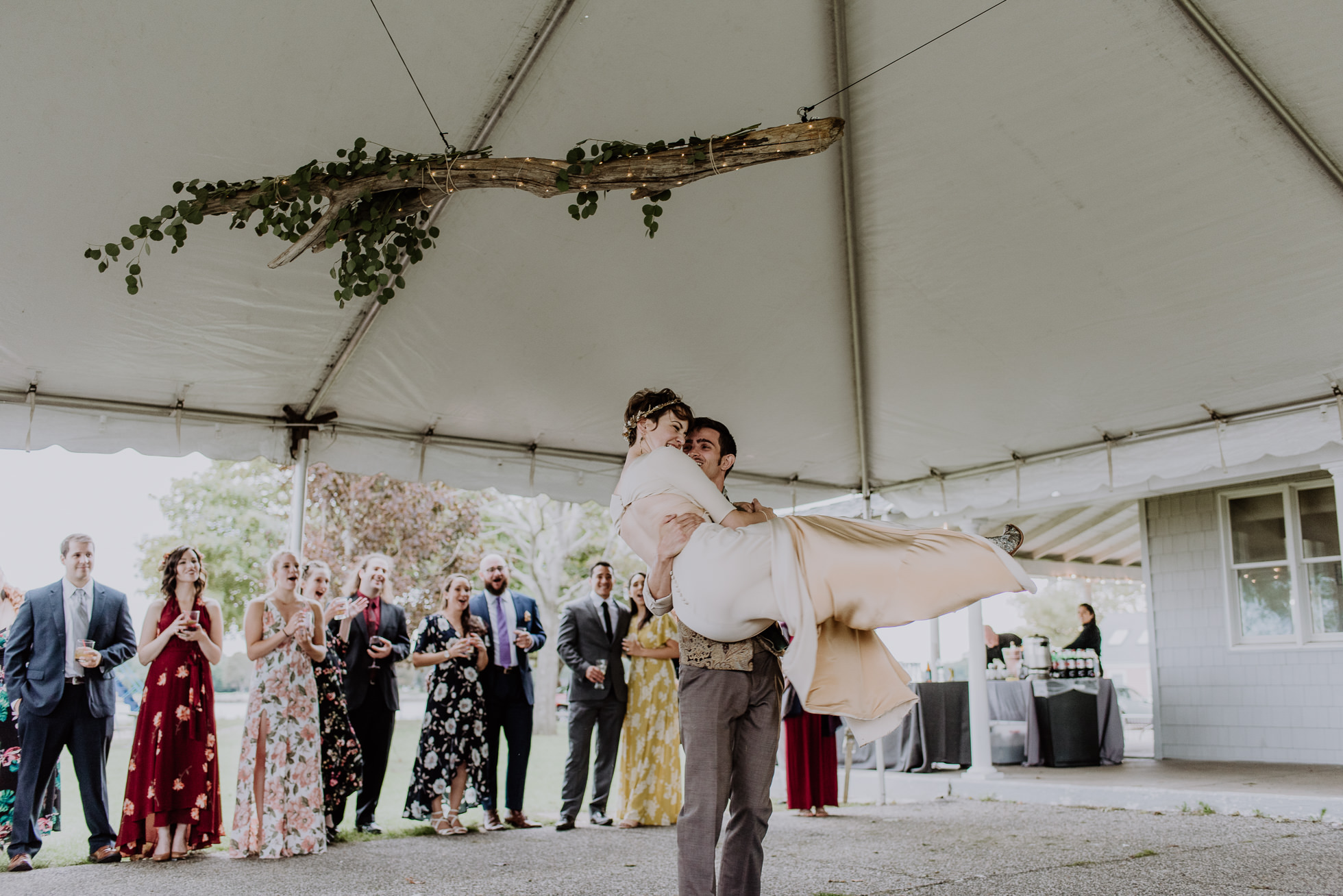 groom carrying bride