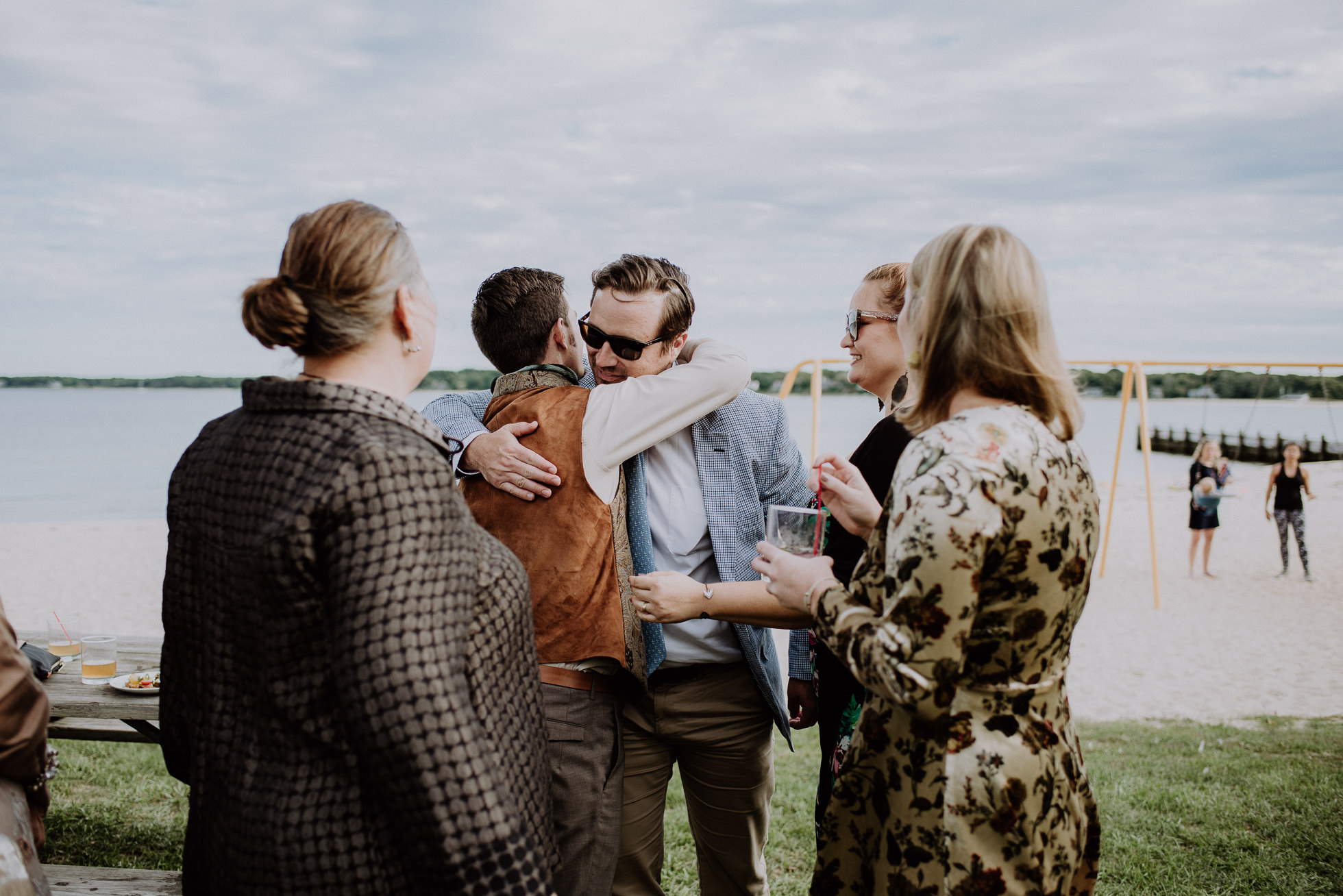 groom hugging guests