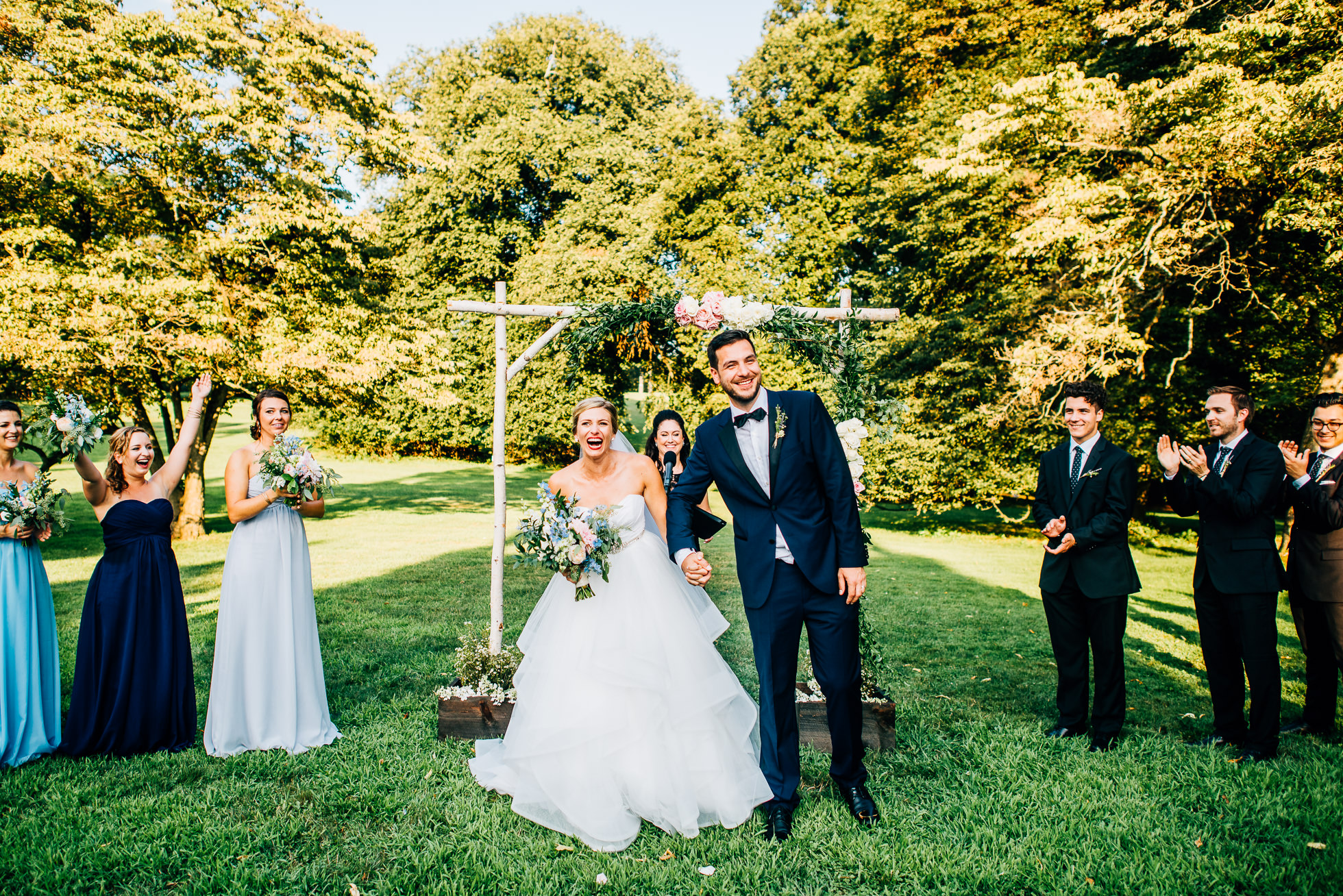 bride and groom exit at wedding ceremony at lyndhurst castle photographed by traverse the tides