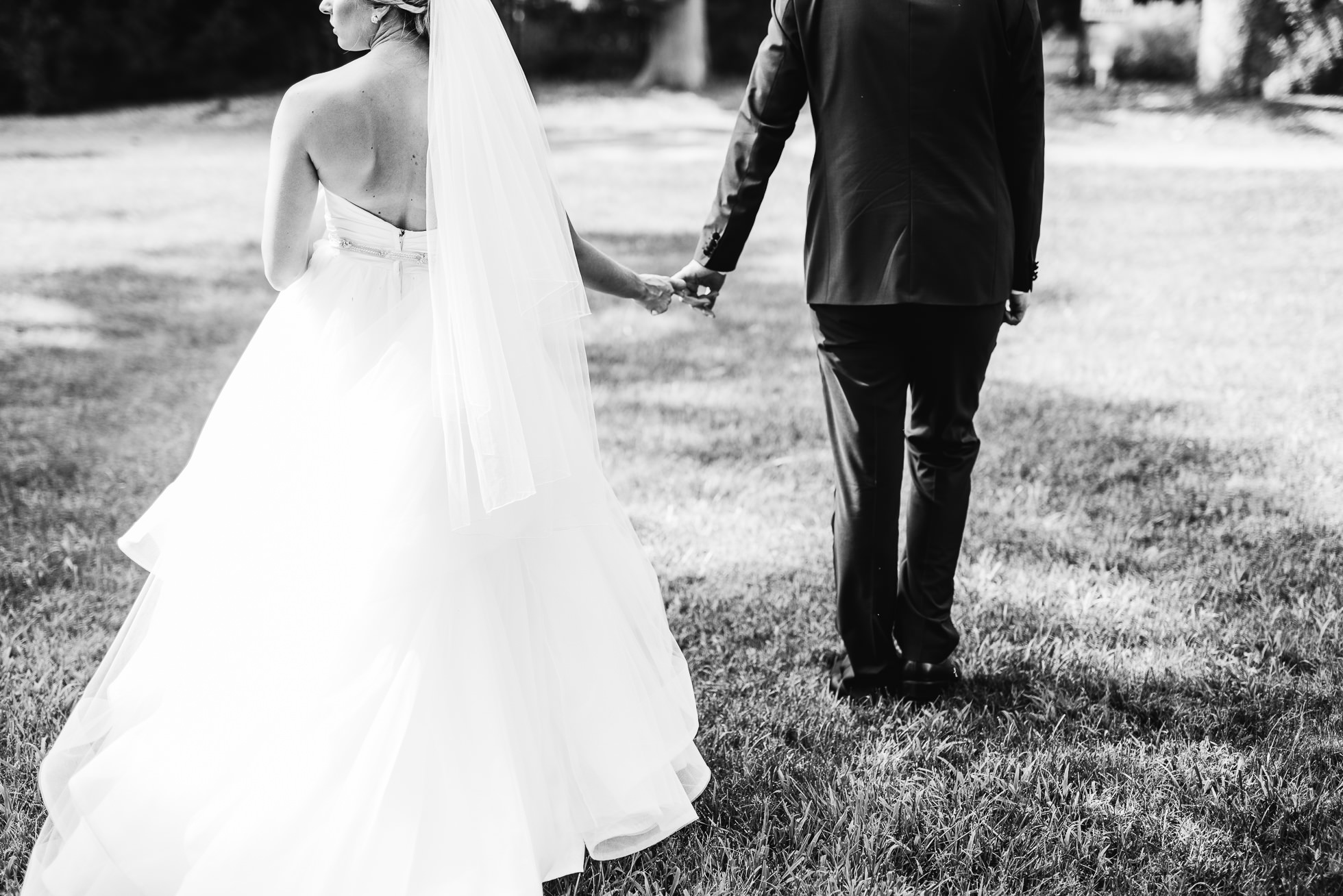 bride and groom hug at wedding ceremony at lyndhurst castle photographed by traverse the tides