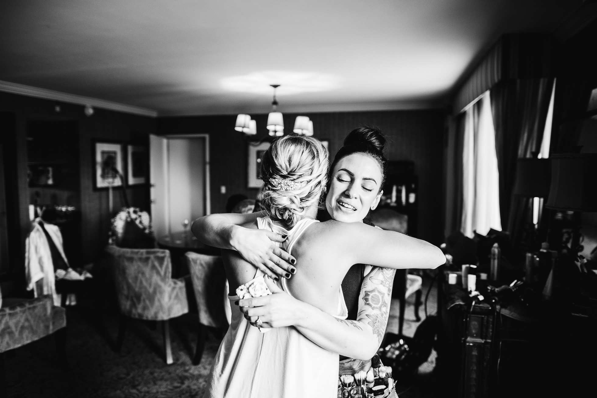 bride hugging at lyndhurst castle wedding photographed by traverse the tides