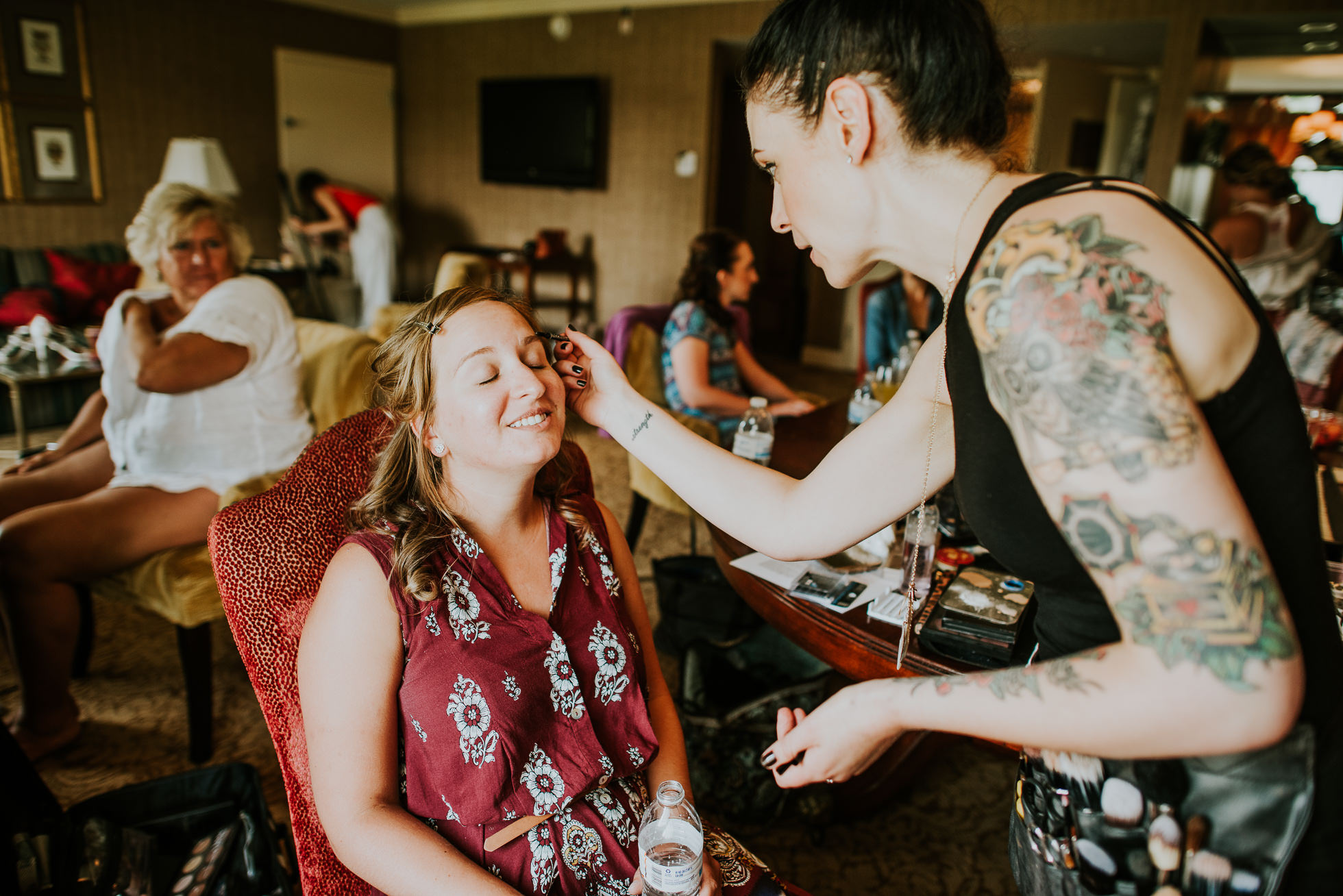 bridesmaid getting makeup at lyndhurst castle wedding photographed by traverse the tides