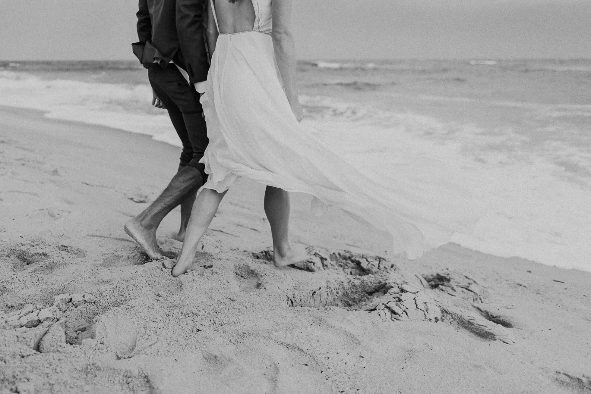 bride and groom walking at beach Montauk wedding photographed by Traverse the Tides