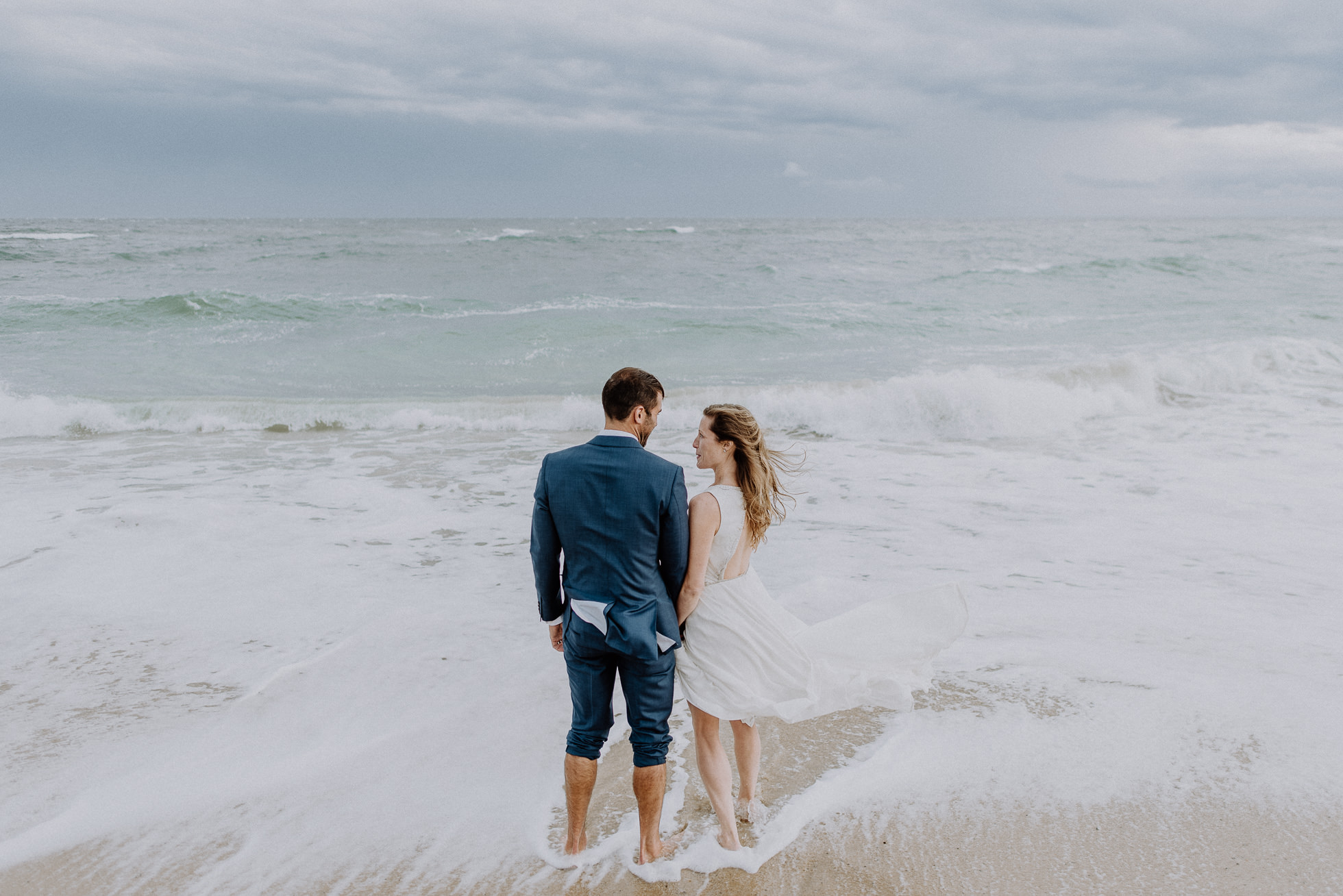 bride and groom going in the ocean Montauk wedding photographed by Traverse the Tides