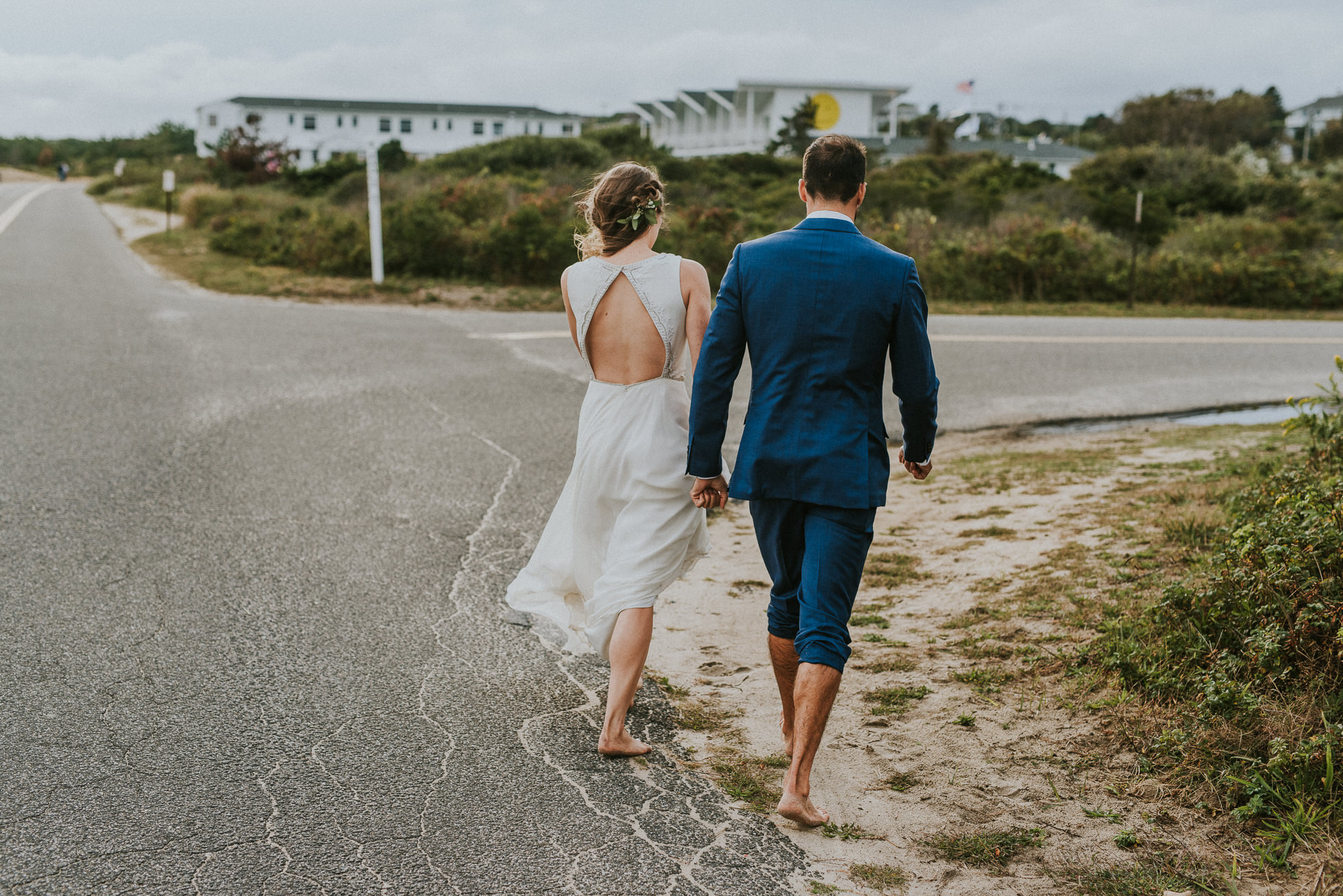 bride and groom walking down the road in Montauk wedding photographed by Traverse the Tides