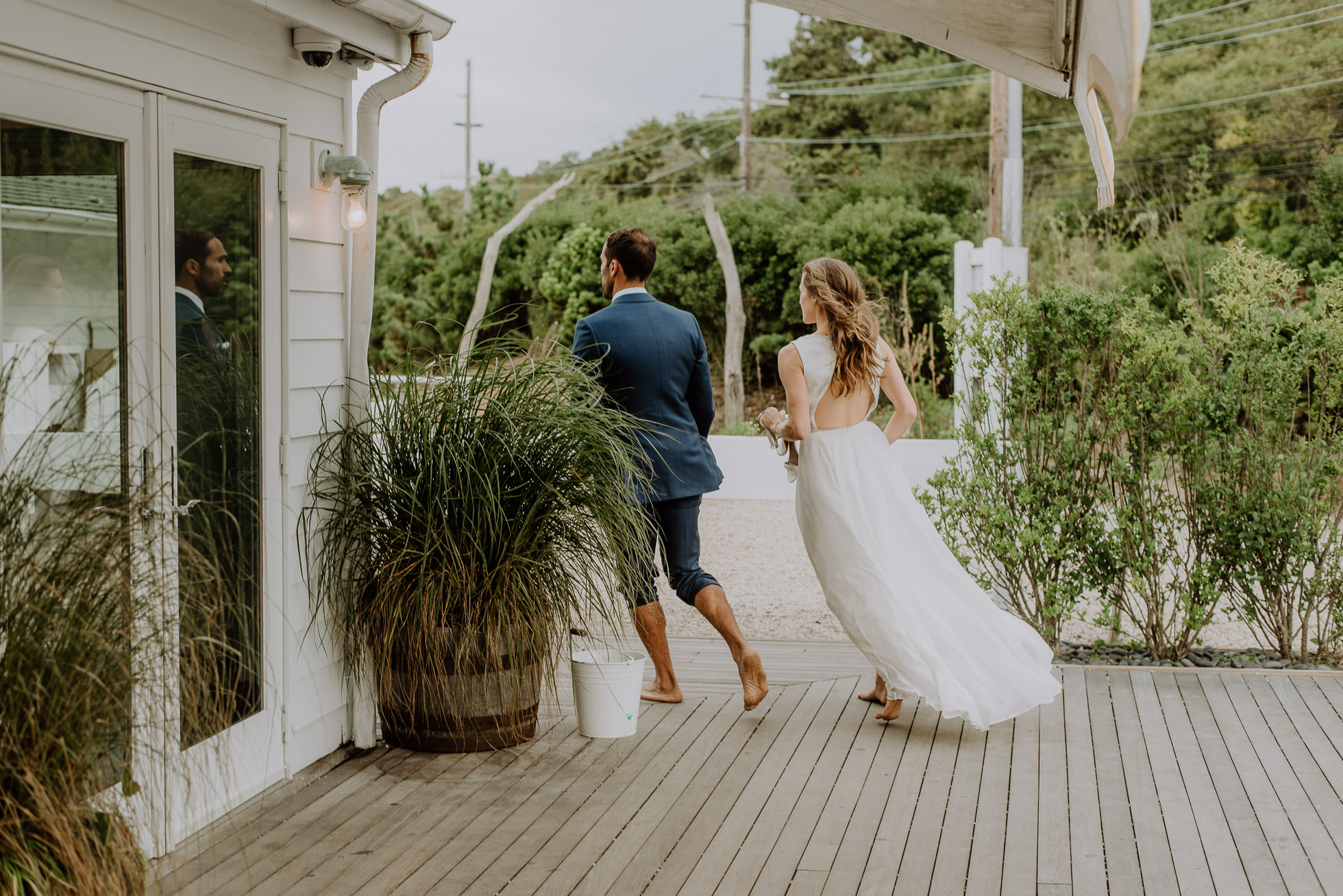 bride and groom returning to reception at the surf lodge in Montauk wedding photographed by Traverse the Tides