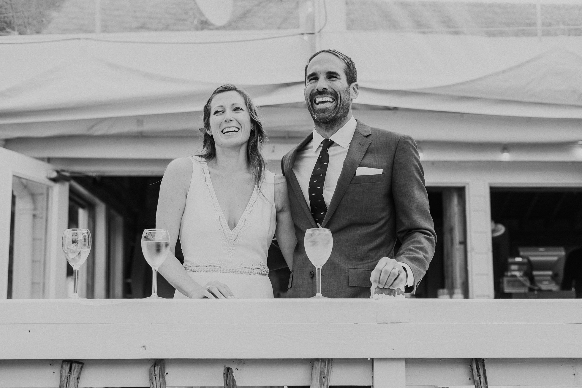 bride and groom laughing maid of honor speech at the surf lodge in Montauk wedding photographed by Traverse the Tides