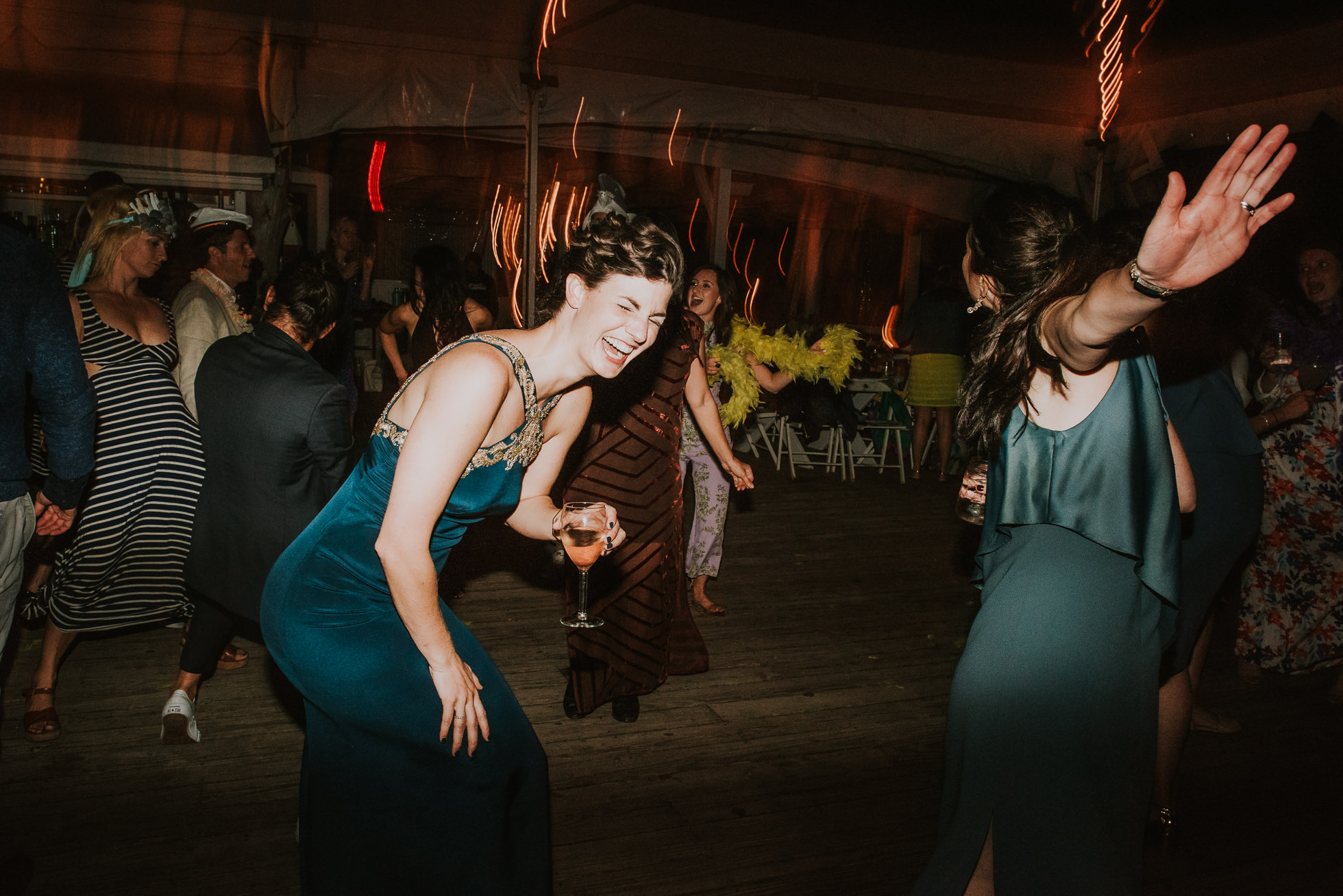 wild guests laughing at reception Montauk wedding photographed by Traverse the Tides