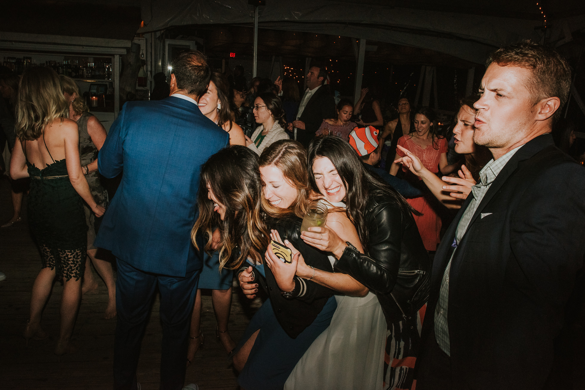 bride hugging friends at reception Montauk wedding photographed by Traverse the Tides