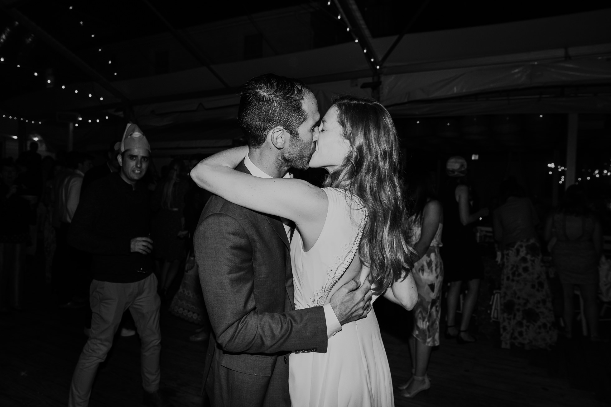 bride and groom kissing at reception Montauk wedding photographed by Traverse the Tides