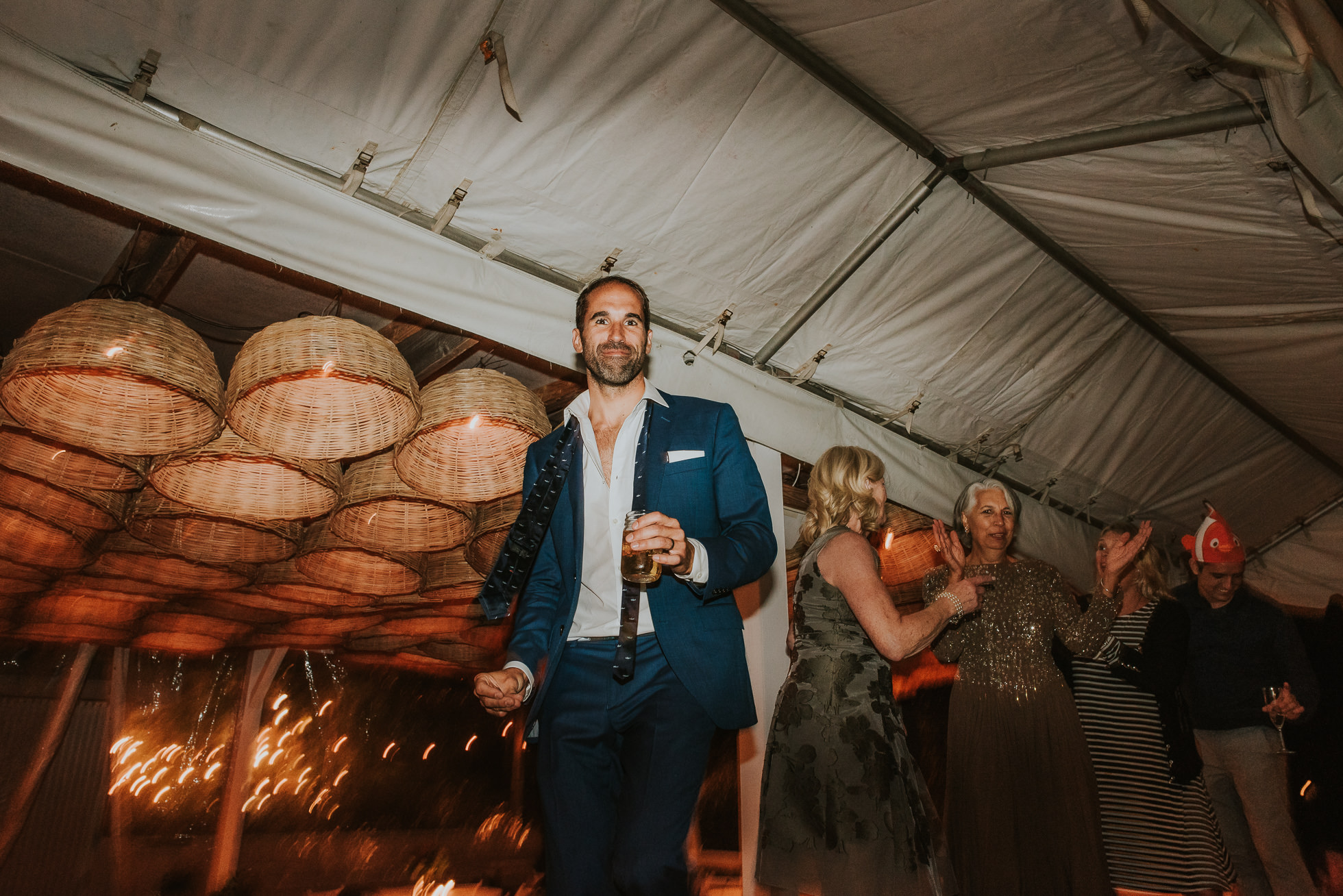 groom dancing on table at Montauk wedding photographed by Traverse the Tides