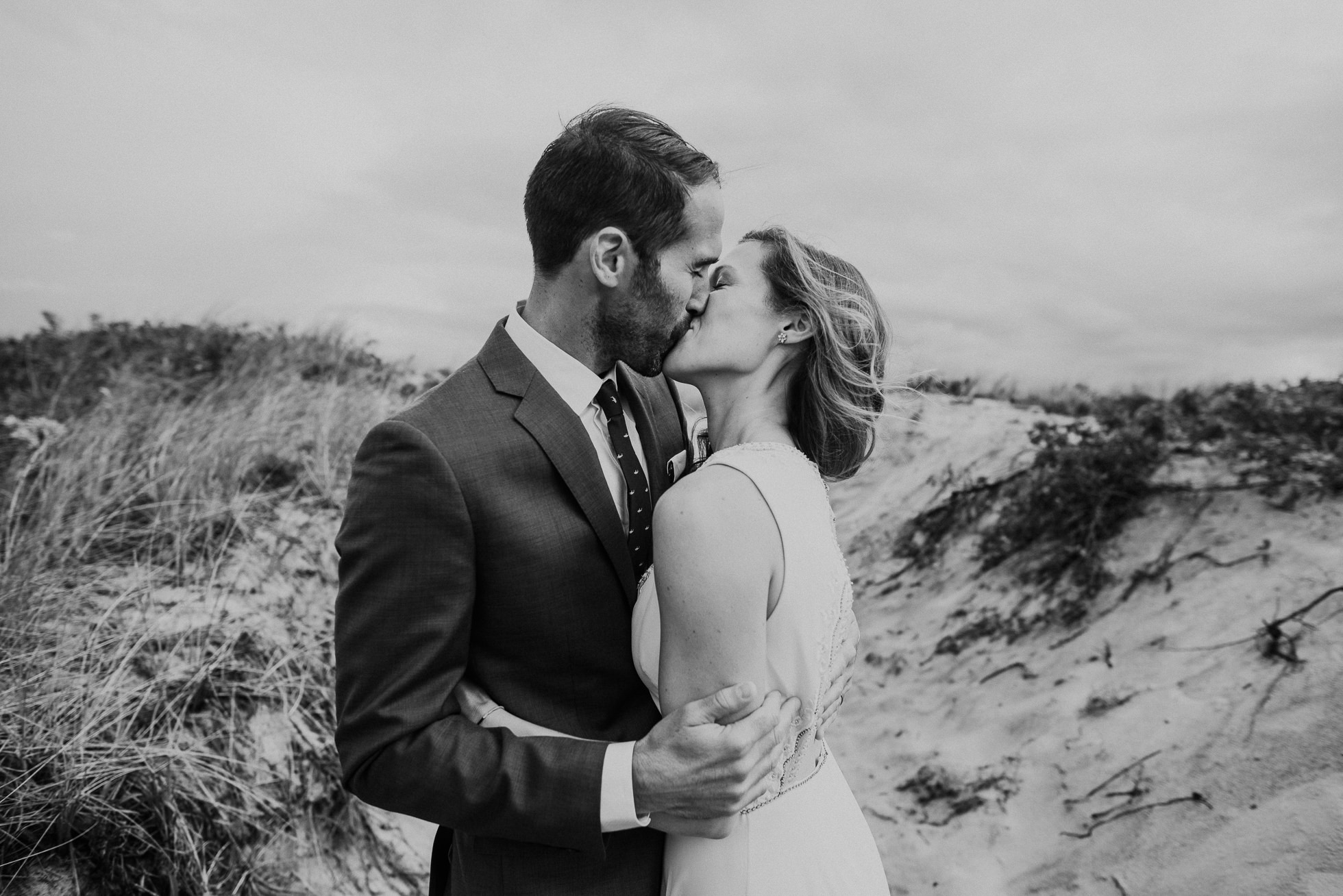 emotional kiss bride and groom at the beach Montauk wedding photographed by Traverse the Tides