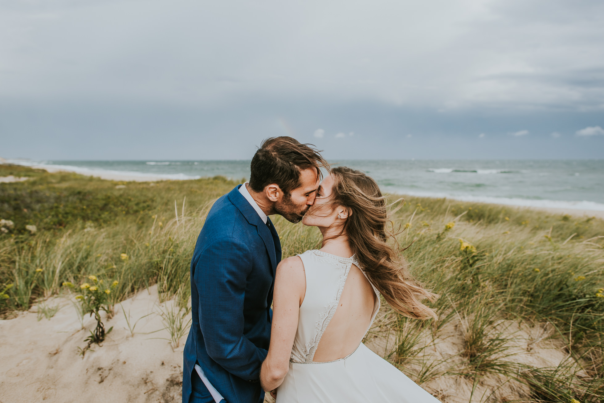 kissing bride and groom at the beach Montauk wedding photographed by Traverse the Tides