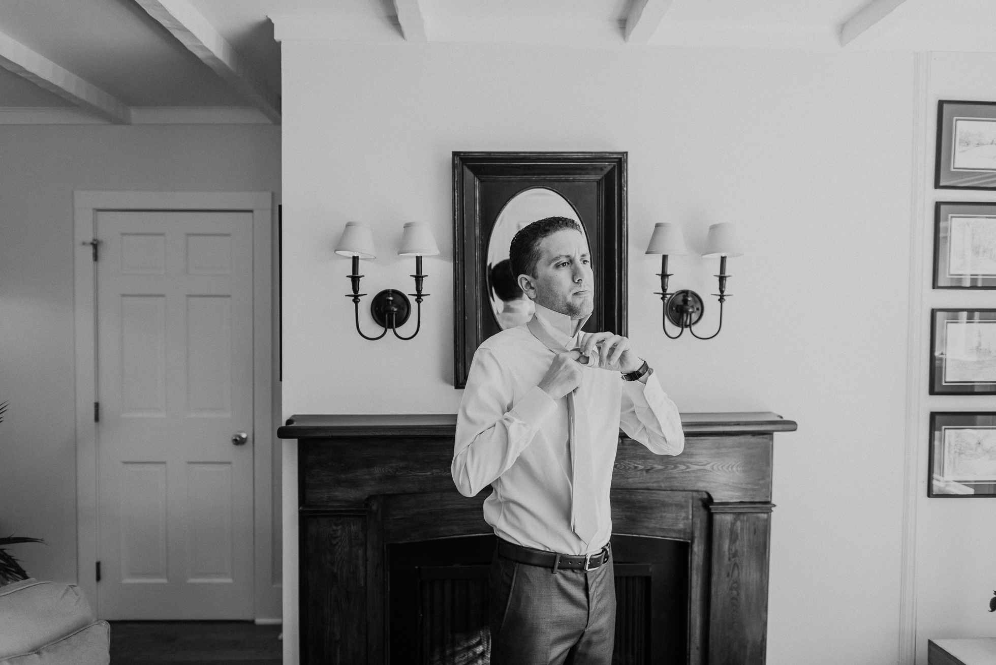 groom tying tie at the Hedges Inn