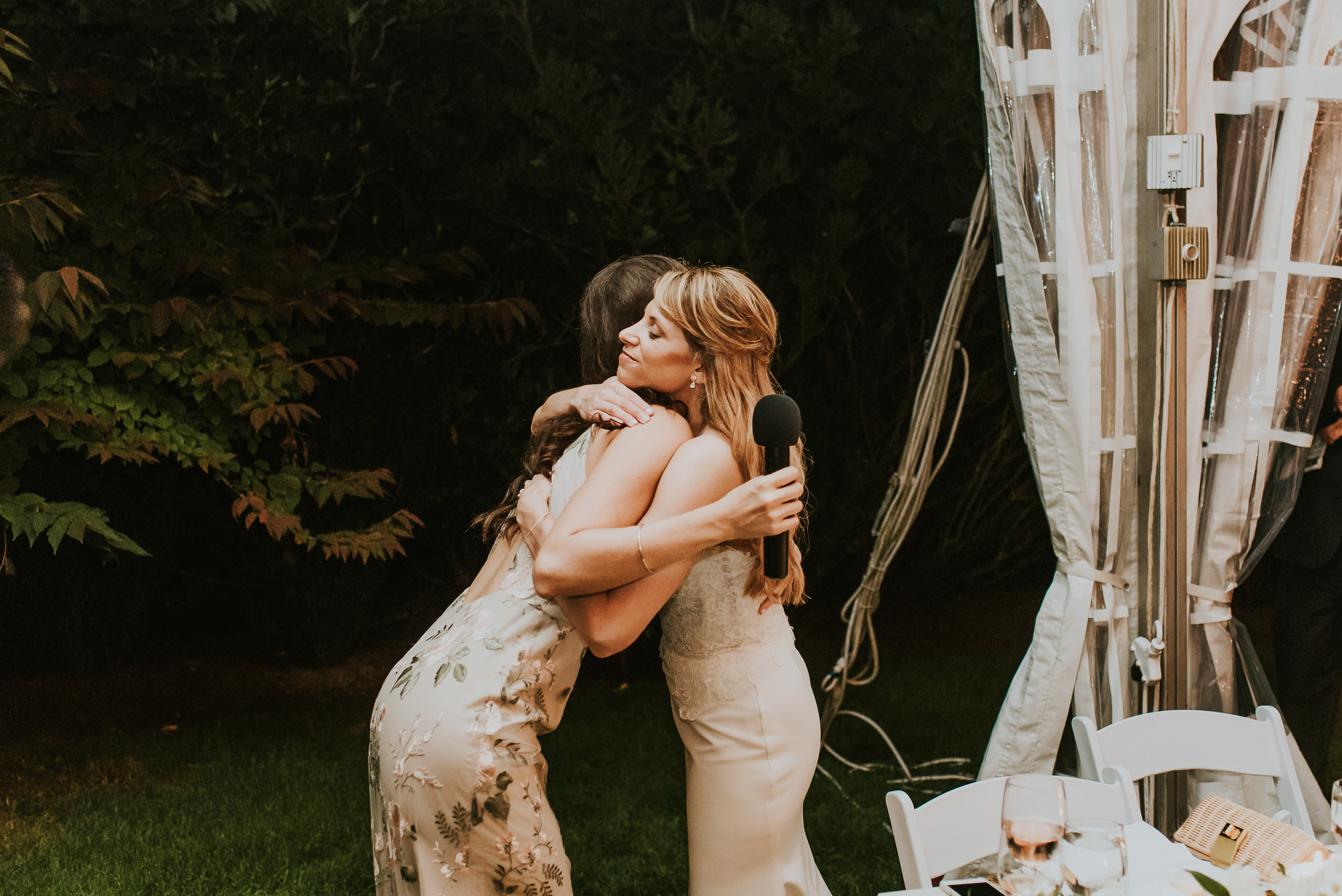 bride and maid of honor hugging the hedges inn wedding