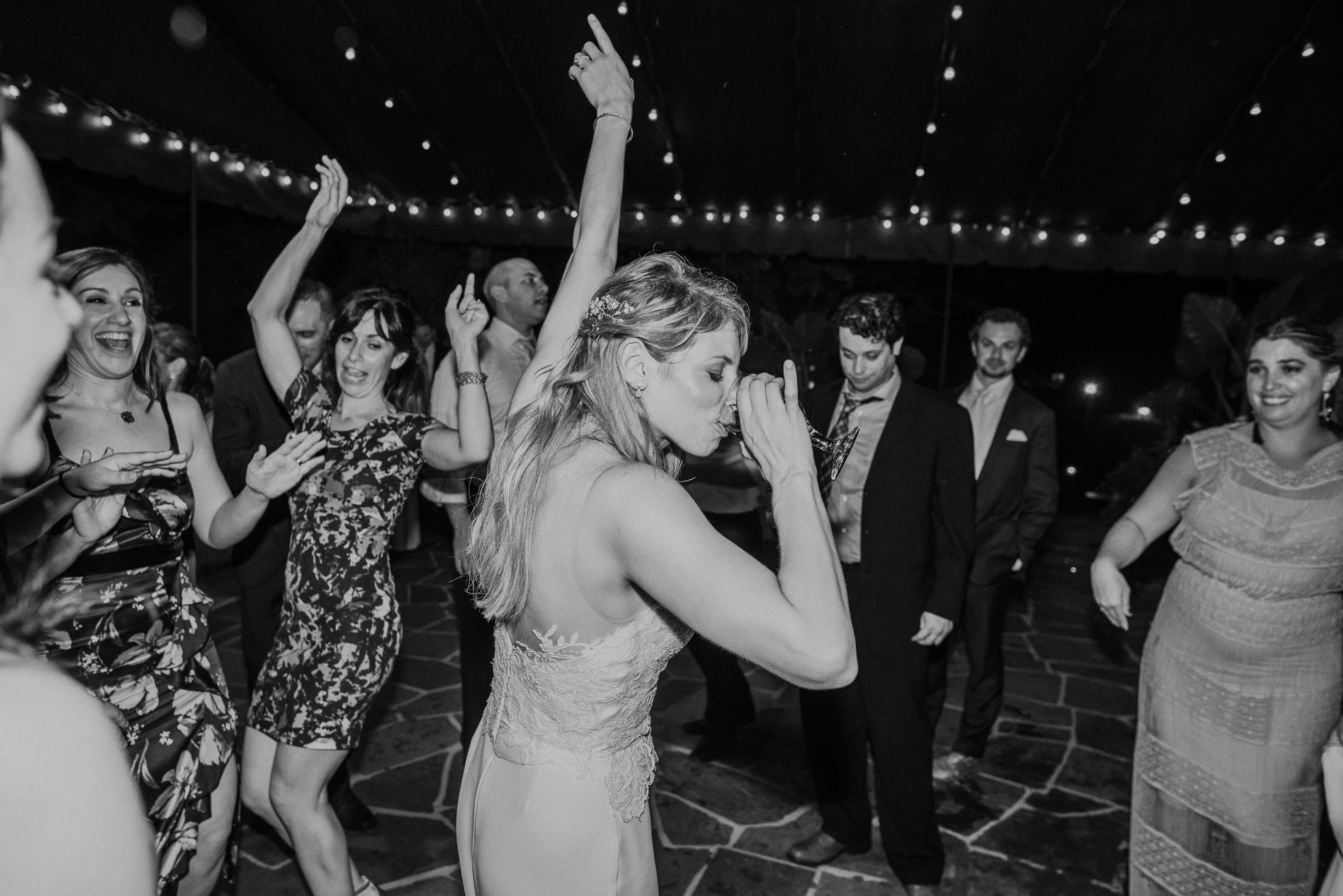 bride drinking wine the hamptons wedding reception