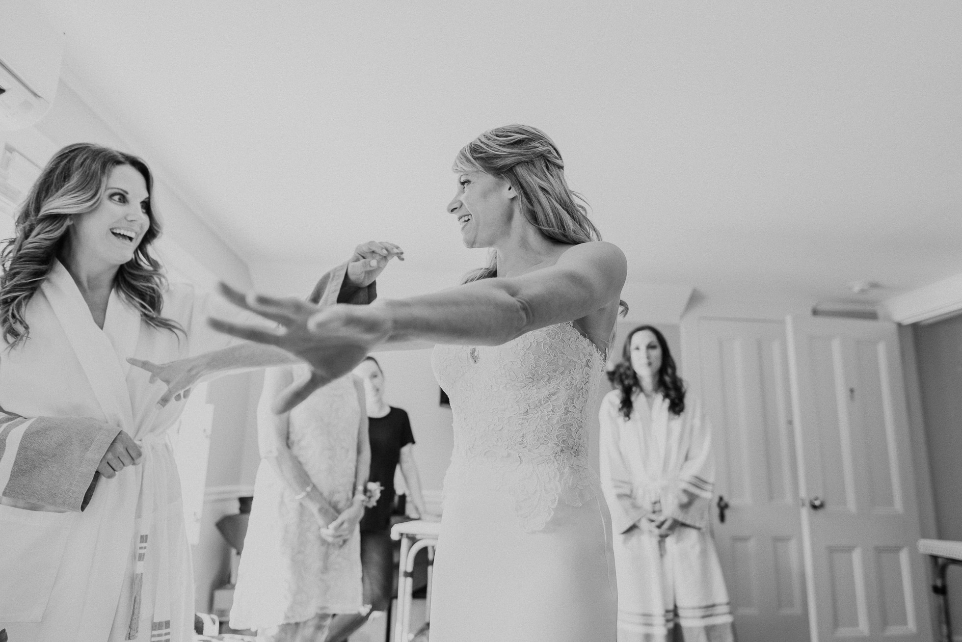 bride getting dressed the Hamptons wedding