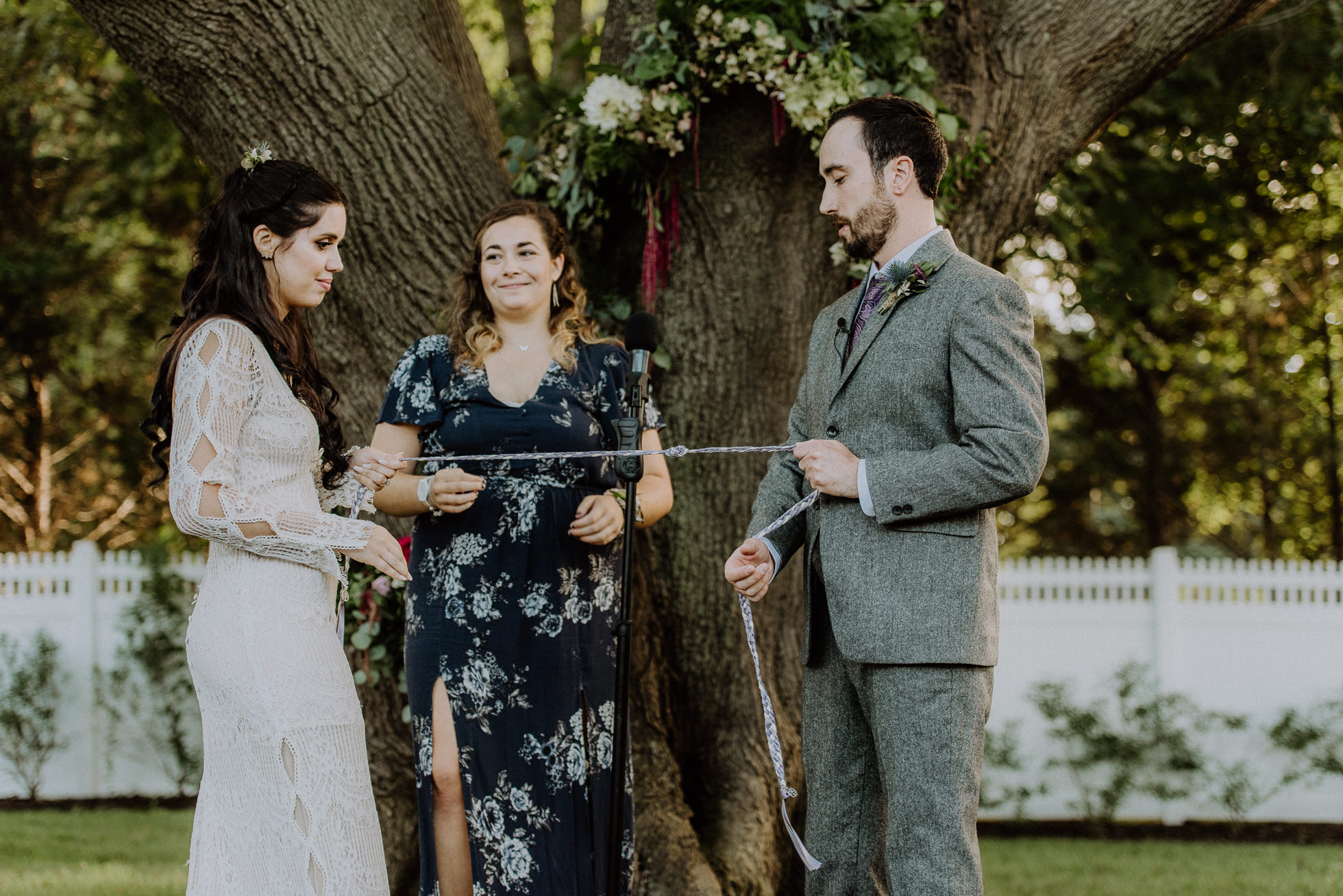 bride and groom tying infinity knot