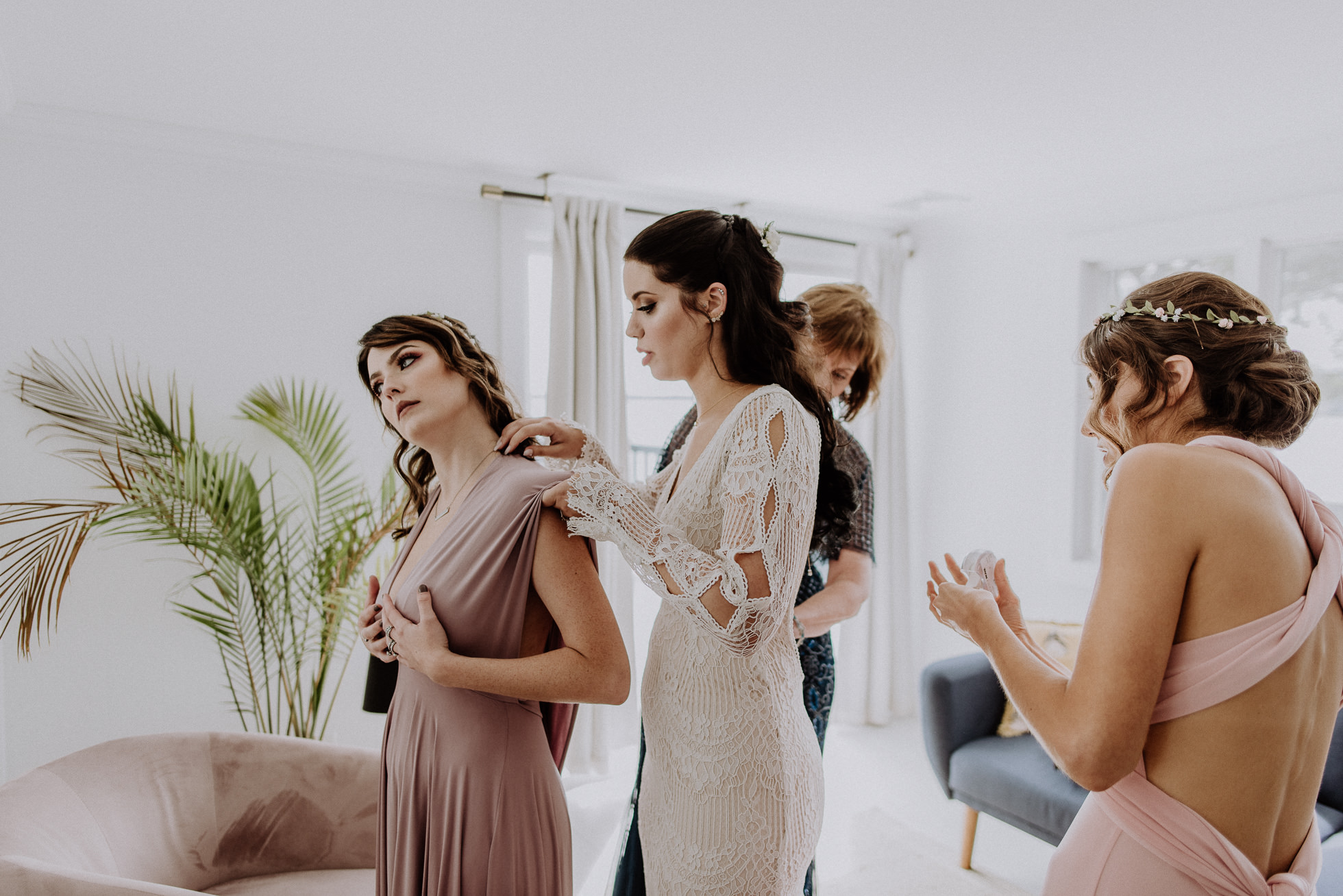 bride with bridesmaids getting ready